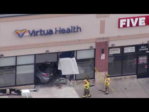 Video | SKYFOX: Car crashes into strip mall in New Jersey, two occupants