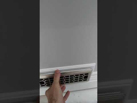 Installing baseboard around floor heater and duct...