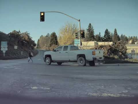 Cop Car Tails Semi Truck Trying to Pass While Pedestrian Crosses Road - 1090608