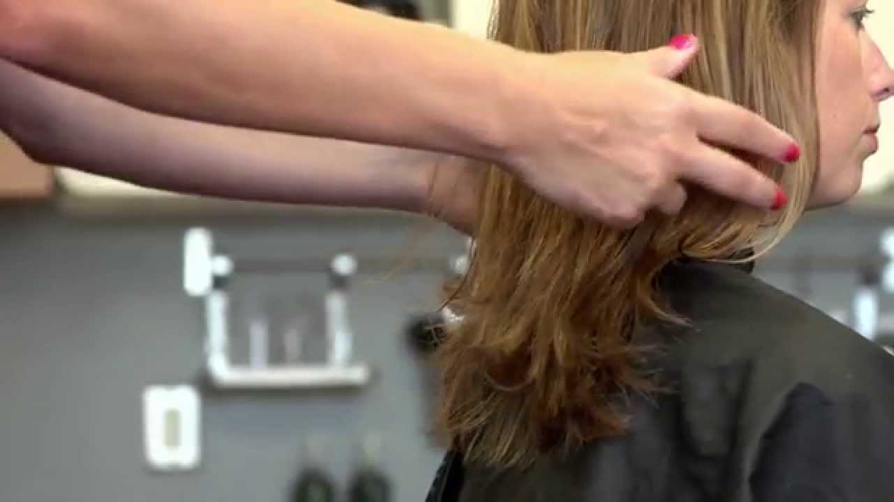 A woman gets her hair styled