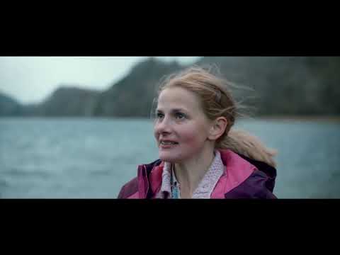 Trailer shot: Charles, in cardigan and jeans, looks toward the hills as gentle score swells