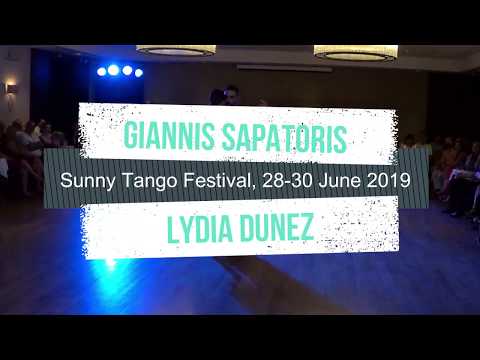  Giannis Sapatoris  and  Lydia Dunez  are  dancing  to  the  tango  "  Café Domínguez  "  by  Ángel D'Agostino  at  Sunny Tango Festival  in  2019