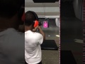 Buddha man showing off his aim at the gun range
