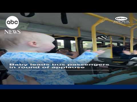 Baby leads bus passengers in round of applause