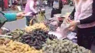 Lady tries to sell her snacks at street market