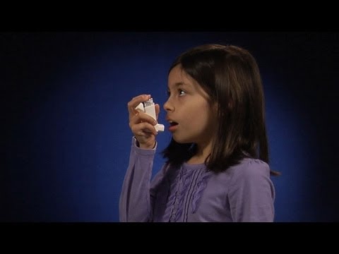 Using a metered dose inhaler one to two inches from mouth
