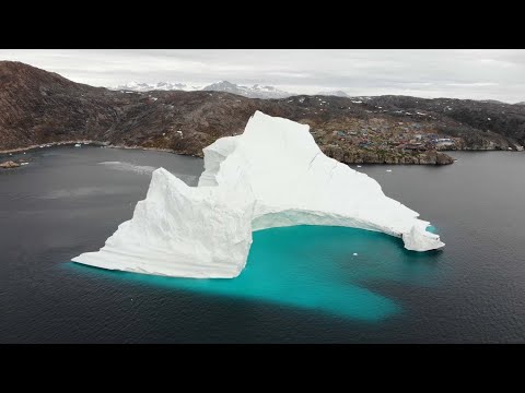 GIANT ICEBERG COLLAPSES,  SWAMPS LOCAL FISHING VILLAGE. BOATS SEEN IN RAW FOOTAGE.