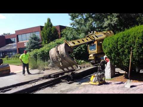 Removing rails and ties along the Upper Falls Greenway at the Oak St. crossing.