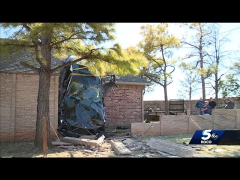 Car lands on OKC home’s roof during crash