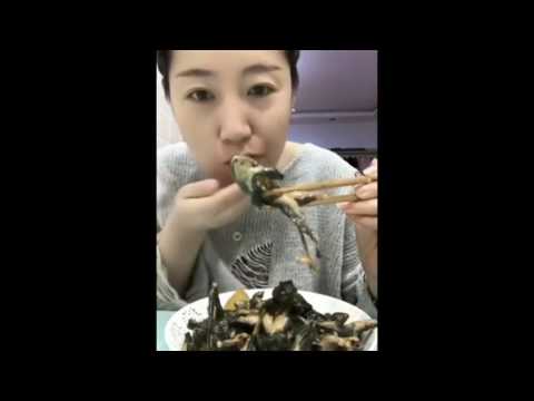 Asian Woman eats FROGS WHOLE.  Woman eats whole frog!!!