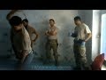 Afghan army torture prisoner as US forces look on.