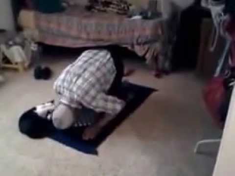 Funny cat plays with a Muslim man