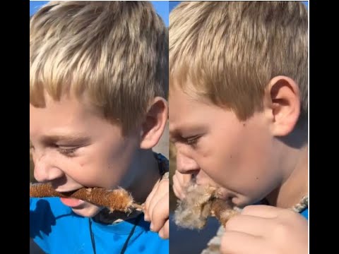 Kid try to eat a marsh cane
