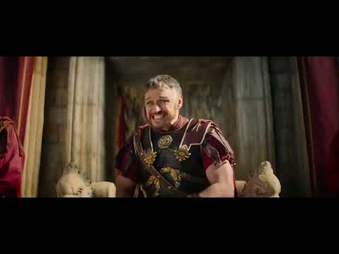 Trailer frame: torchlit night scene with Roman soldiers as drums build tension