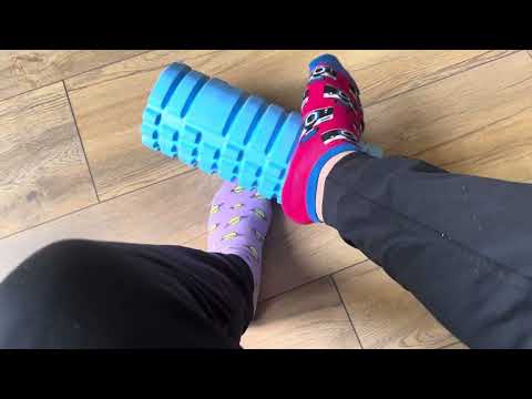 Mismatched socks playing with a foam roller