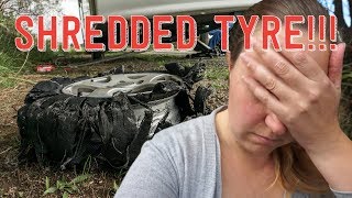 Flat caravan tyre on side of road