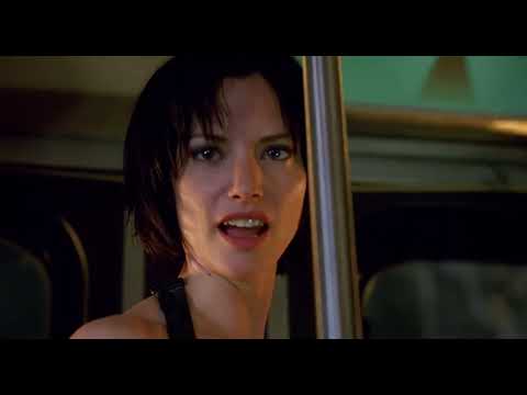 Trailer still — the church set-piece where Danna’s cue surges while Alice enters on a motorcycle