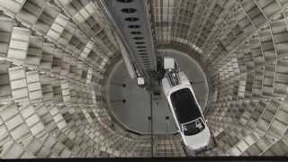 Two gleaming glass towers of volkswagens autostadt or car town house technology which automatically moves cars from vws wolfsburg plant to..