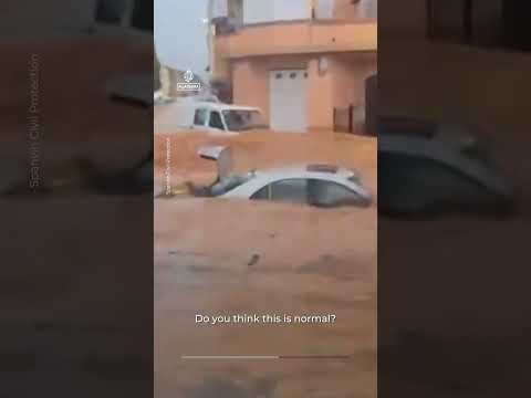 Floods sweep cars through streets after intense rain in Spain