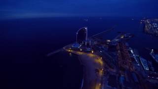 Barcelona Port Vell Yacht Harbor and Beach Nighttime Aerial Tour (4k footage)