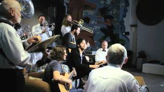 The John Steel Singers perform Overpass with a marching band