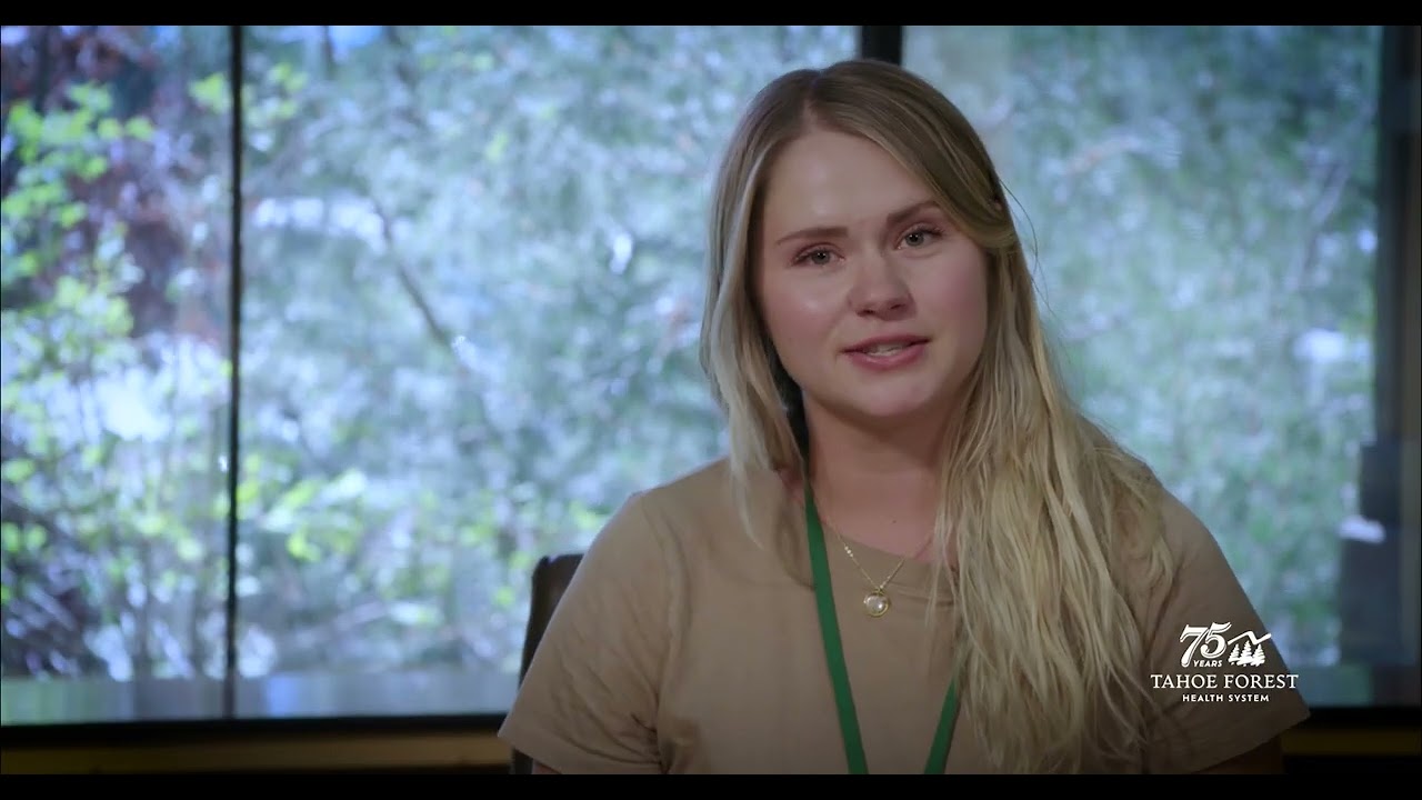 Justine Nelson, Integrative Wellness Coach at Tahoe Forest Hospital, sitting in front of a window
