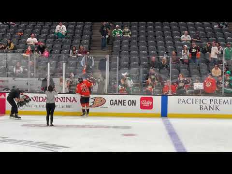 Trevor Zegras gives stick to a fan before the game