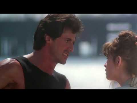 Rocky III official trailer frame: Rocky and Clubber Lang framed by flashbulbs before the title card