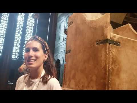 Tourguide explaining about d seat of Charlemagne inside Aachen-cathedral in Aachen, Germany