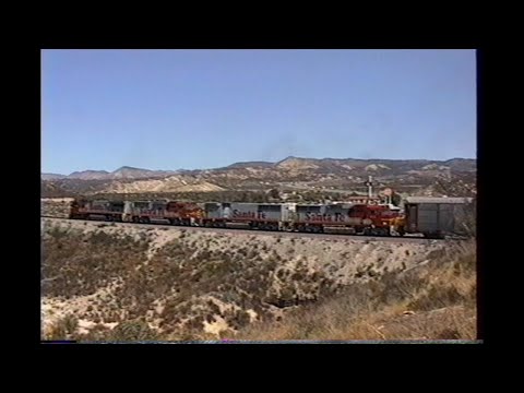 1169. SANTA FE ATSF east with WAR BONNET units on Cajon Pass California on August 25 1993 with 4 fre