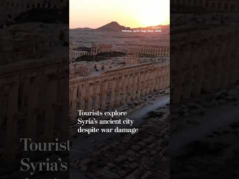 Tourists explore Syria's ancient city despite war damage