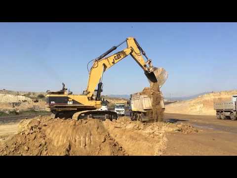 Caterpillar 375 Excavator Loading Trucks