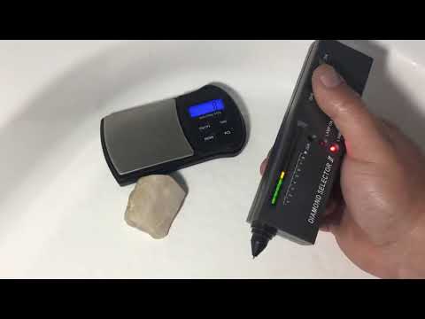 Diamond selector two testing white rough uncut diamonds