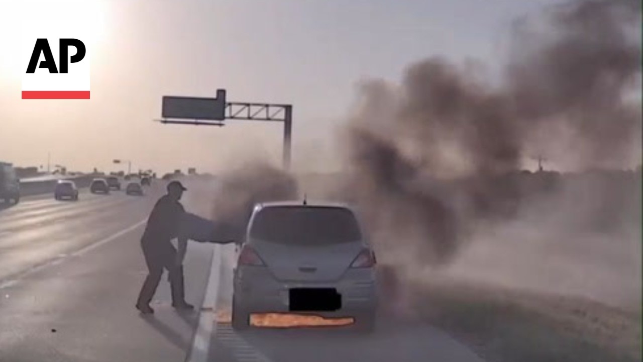 Video: Texas officer pulls man from burning car on Highway 114