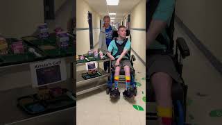 Sam pushing the breakfast cart at school. Oops he hit something.