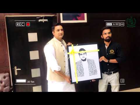 Presenting a handmade portrait to DC Islamabad Hamza Shafqaat.