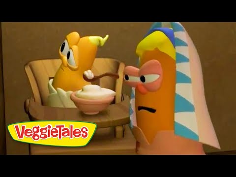 Animated VeggieTales scene: two cartoon vegetables at a table, one offering a bowl of dessert to the other, with a colorful towel-wrapped figure nearby.