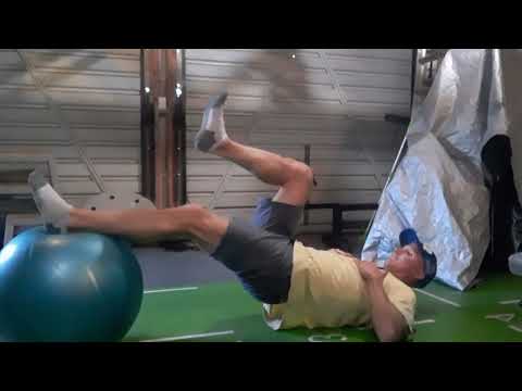 Gym Exercise. Swiss ball hamstring curls