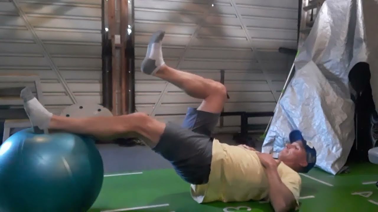 Gym Exercise. Swiss ball hamstring curls