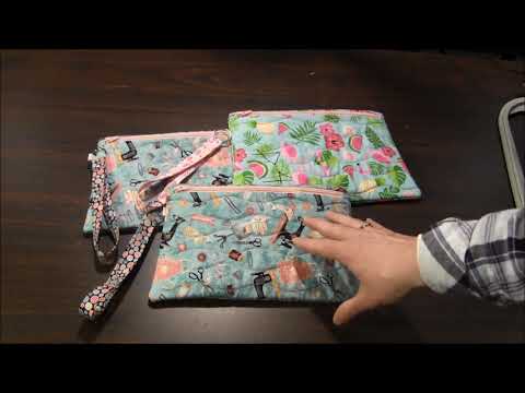 Learn about this Machine Embroidered Wristlet Zipper Bag
