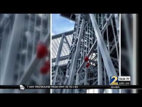 Boxing gloves hang from Olympic tower honoring Muhammad Ali