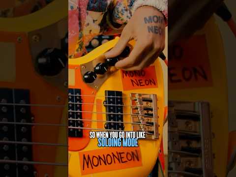 @TheMonoNeon shows off his SIGNATURE BASS, complete with sock & stickers!