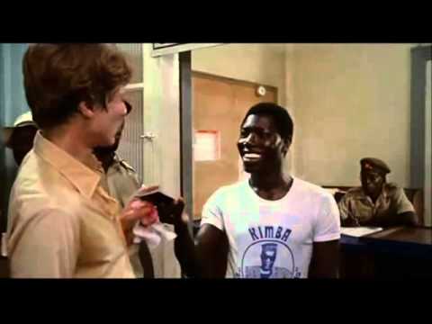 You can't leave Zangaro without your passport... Asshole! (The Dogs of War [1980])