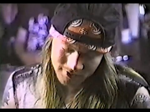 Axl Rose singing on a barstool