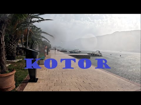 You are walking in Kotor, Montenegro, under heavy summer rain
