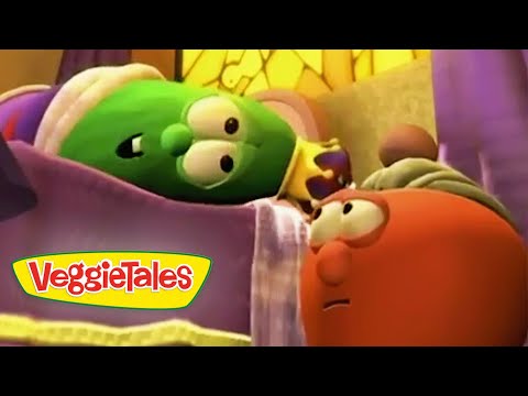 Two VeggieTales characters in a bed scene: a green vegetable lying under a blanket and a red-orange character looking at it as if talking, with a VeggieTales logo visible on the blanket.