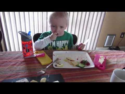 Everette ( with Nana's help ) cutting the cheese. And the strawberries, too!