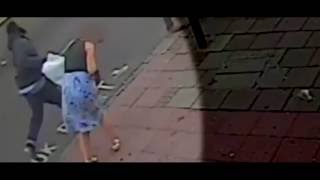 Black man runs up behind a white lady and sucker punches her in the back of the skull