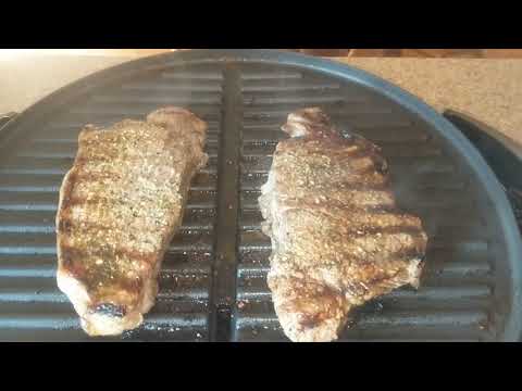 Cooking two MIGHTY 20 oz. New York Strip Steaks on a...