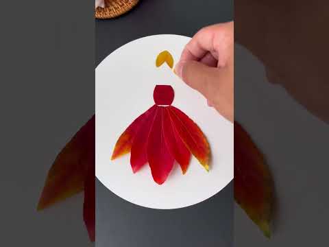 Use autumn red fallen leaves to collage a beautiful little princess. Leaf stickers. Leaf painting k